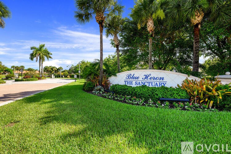 A sign that says "Bil Haver" is in front of some trees.