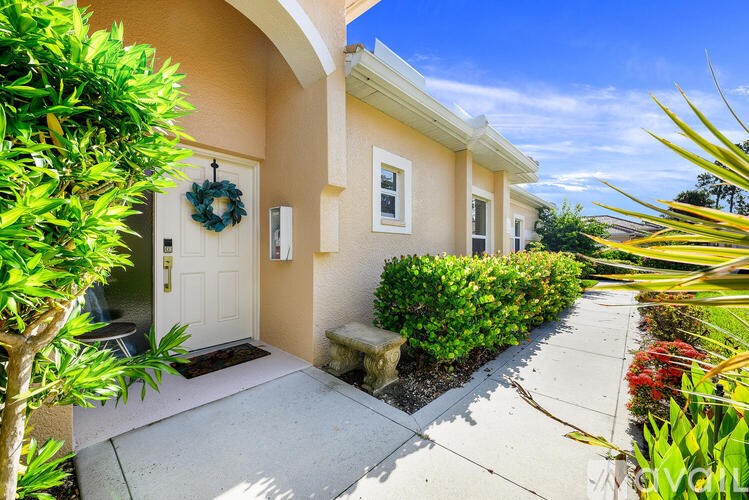 A house with a white door and a wreath on it.