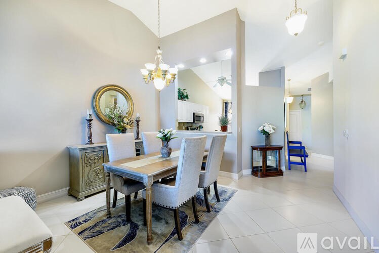 A dining room with a wooden table and chairs.