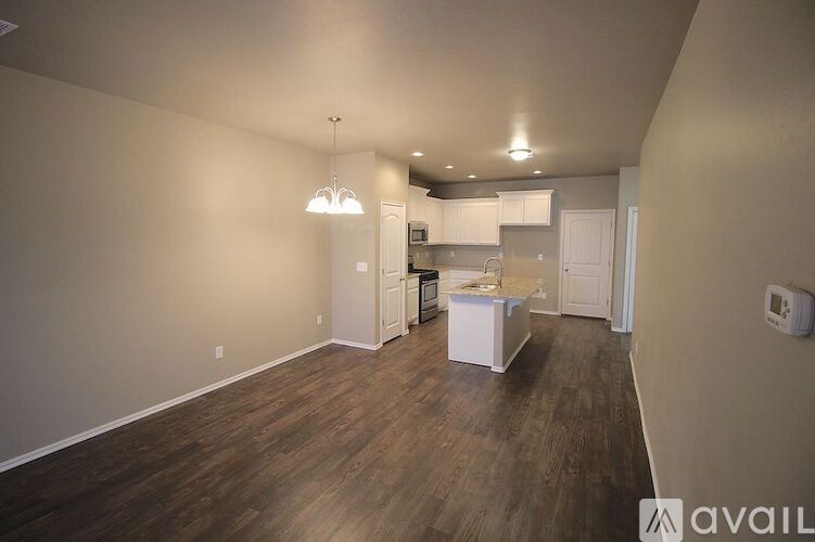 A kitchen area with a white cabinet and a white countertop.