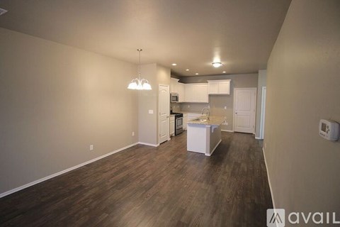 A kitchen area with a white cabinet and a white countertop.