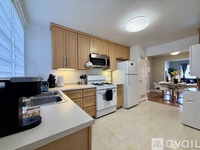 A kitchen with wooden cabinets and white appliances.