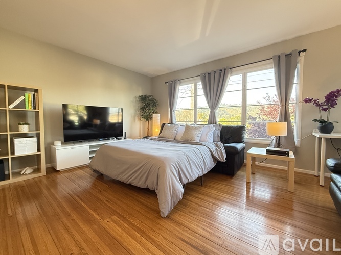 A bedroom with a large bed and a television.