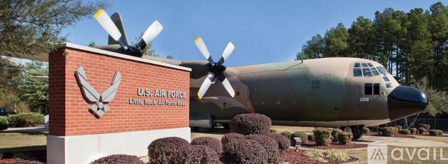 A large military plane is parked in front of a sign that says "U.S. Air Force".