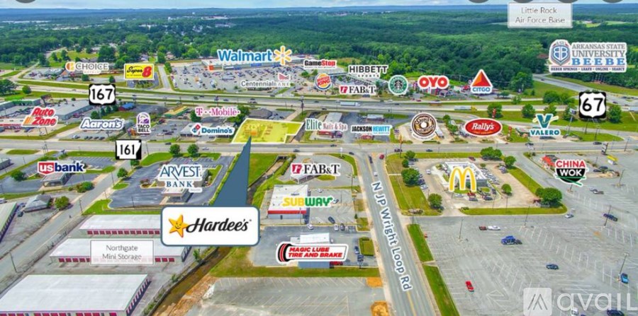A shopping center with a variety of stores including Walmart, Arvest Bank, and Hardee's.