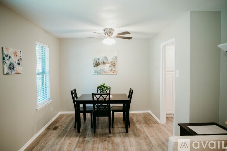 A dining room with a table and chairs.