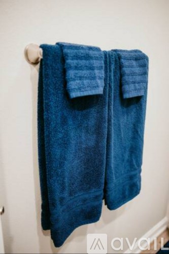 A blue towel is hanging on a towel rack.
