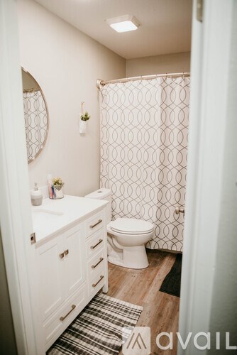 A bathroom with a toilet, sink, and shower.