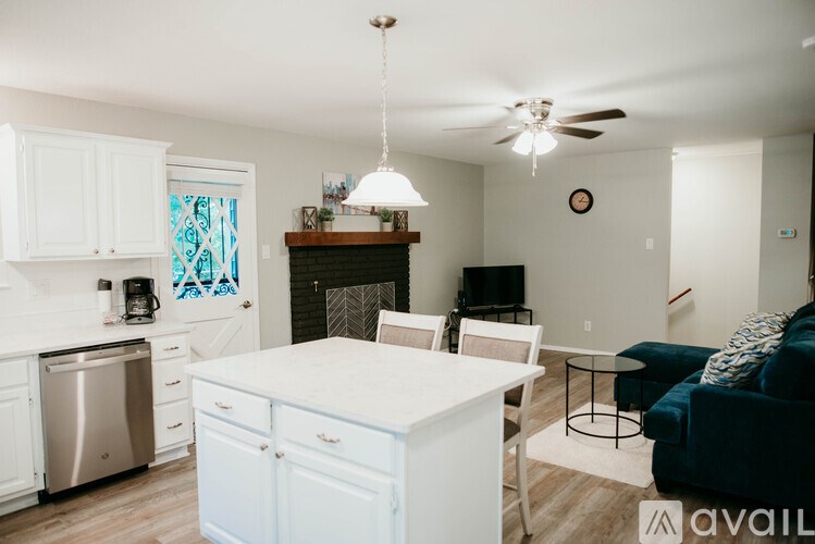 A modern kitchen with white cabinets and a stainless steel dishwasher.
