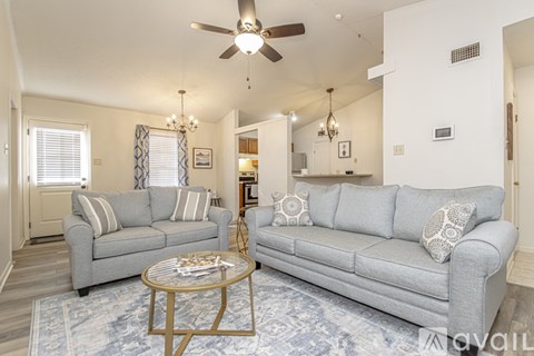 A living room with a grey couch and a coffee table.