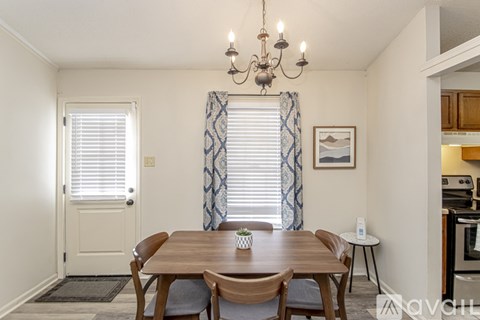 A dining room with a wooden table and chairs.