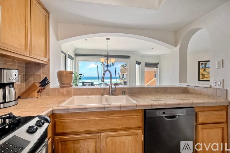 A beachfront property with a pool and palm trees.