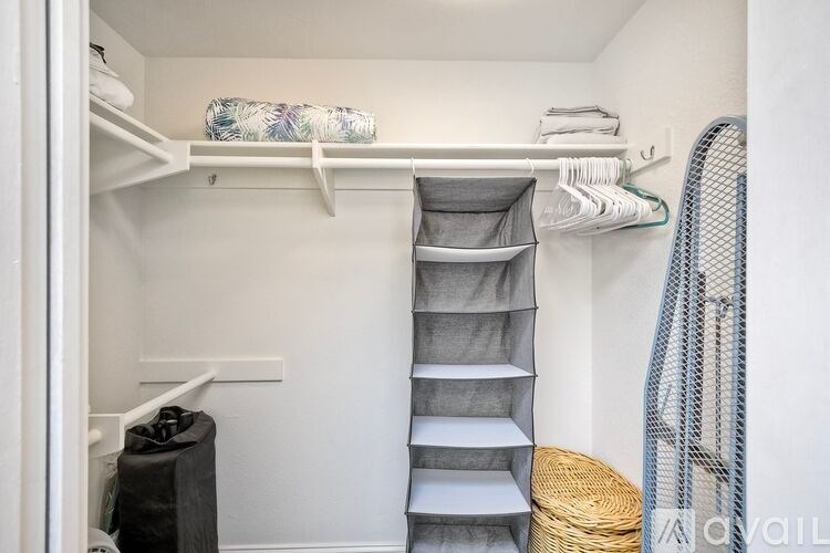 A bathroom with a toilet, sink, and mirror.