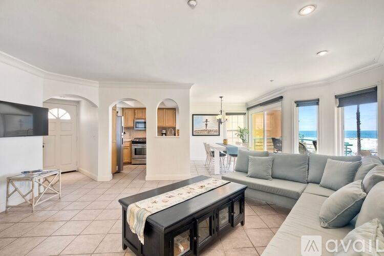 A living room with a black coffee table and a light blue couch.
