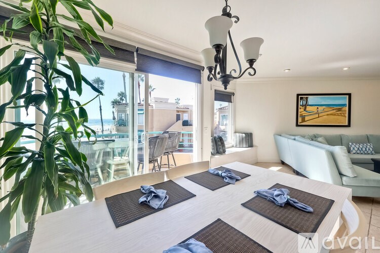 A dining room with a large table set for four.