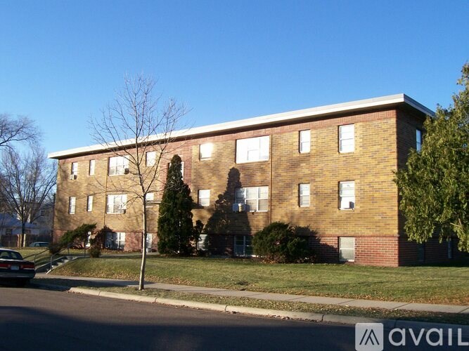 A brick building with a tree in front of it.