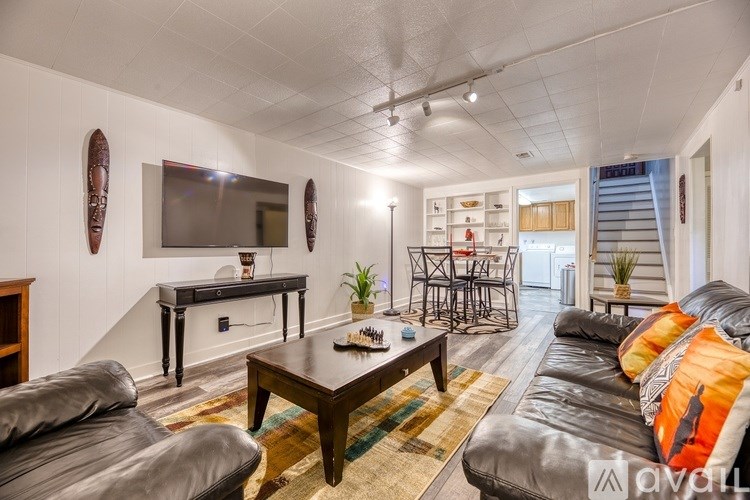 A living room with a grey couch and a wooden coffee table.