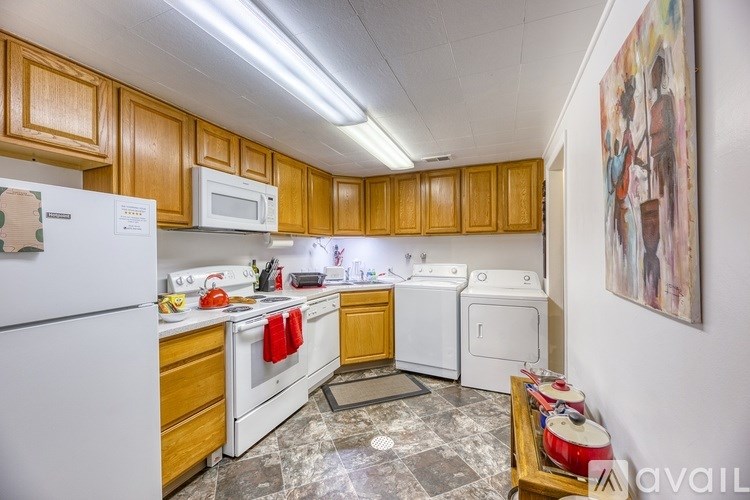 A kitchen with wooden cabinets and a white refrigerator.