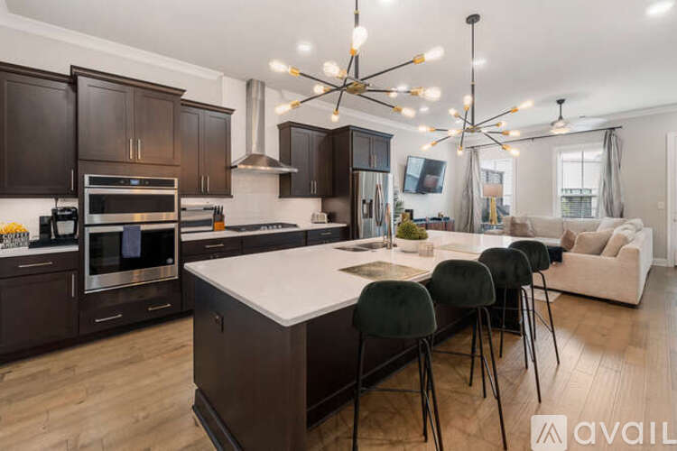 A modern kitchen with dark wood cabinets and a white island.