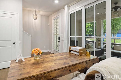 A living room with a wooden table and a white couch.