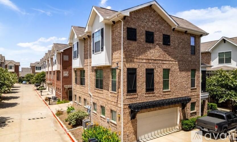 A row of houses with a truck parked in the driveway.