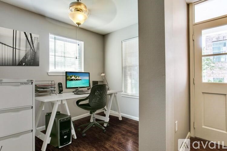 A room with a desk and a computer.