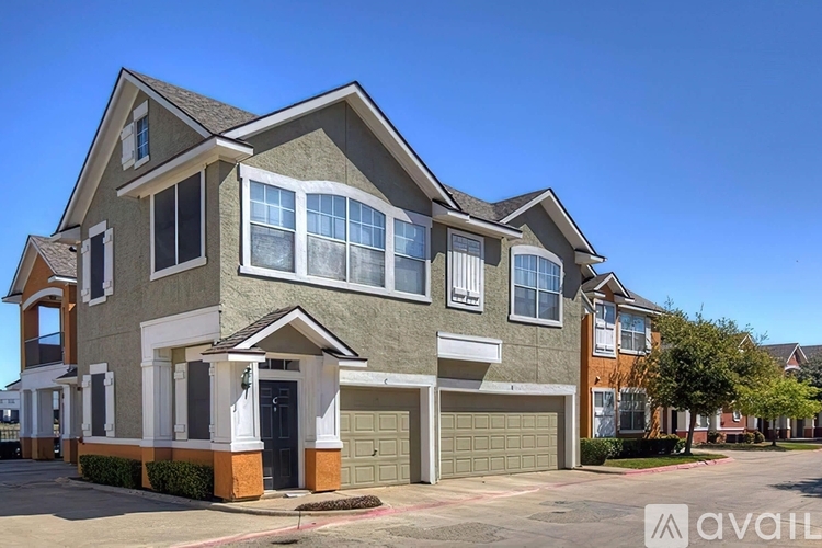 A two-story house with a garage is available for sale.