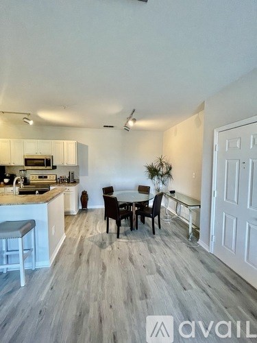 A kitchen with a dining table and chairs in the middle of the room.