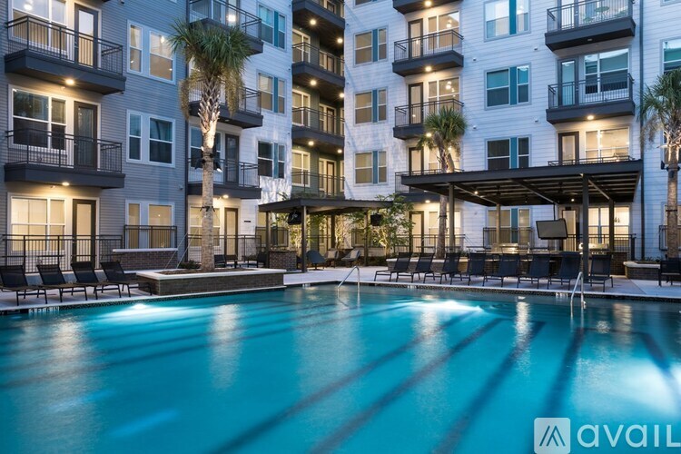A swimming pool in front of a multi-story apartment building.