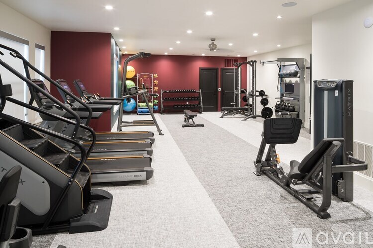 A gym with treadmills, weights, and exercise equipment.