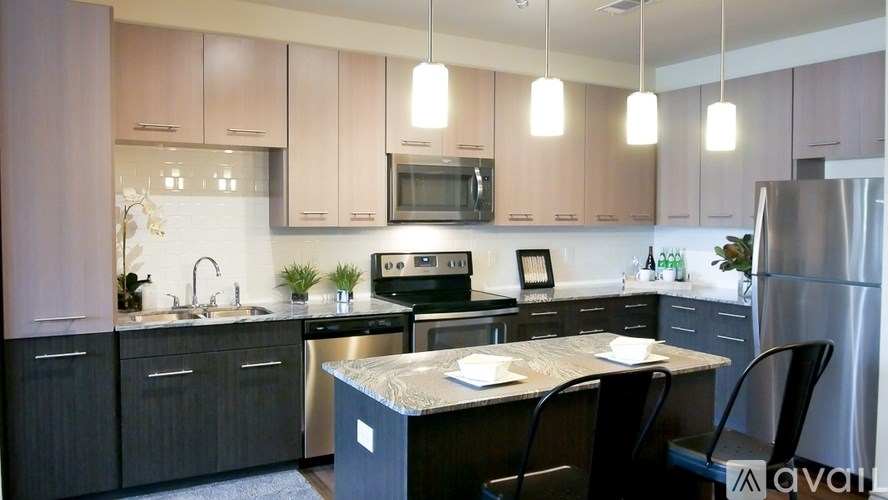 A kitchen with a black countertop and a sink.