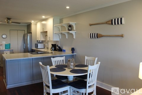 A kitchen with a table and chairs.