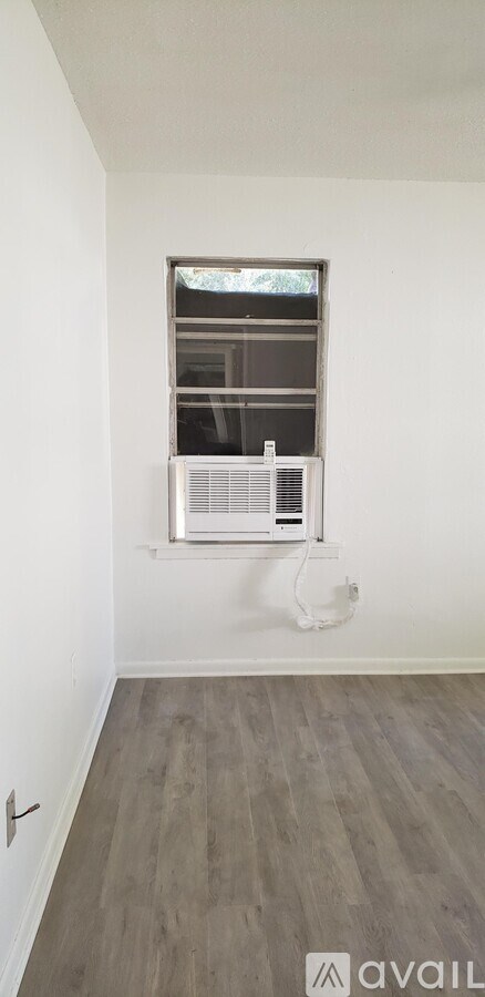 A room with a window and a fan.