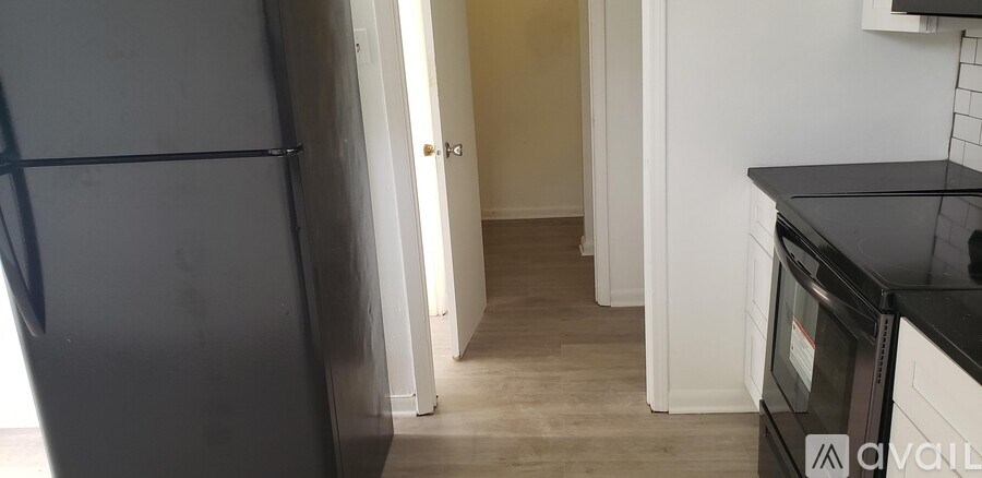 A kitchen with a black fridge and microwave.