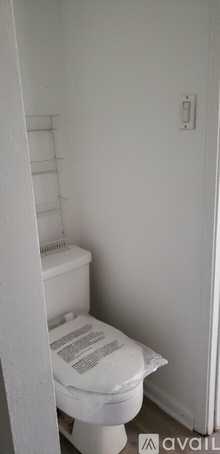 A white toilet in a small bathroom.
