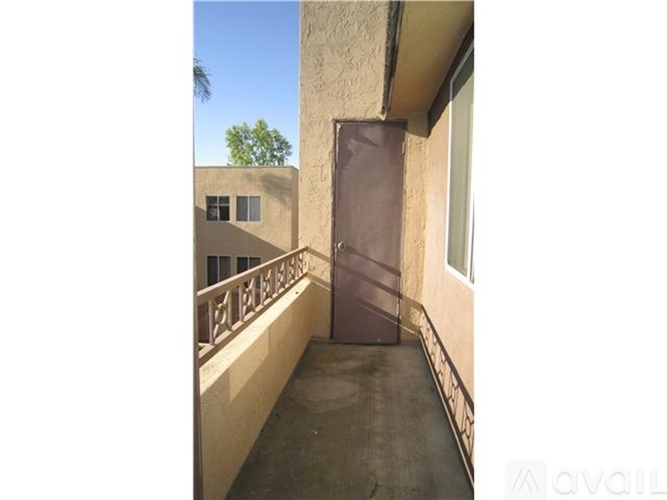 A room with a window and a grey floor.