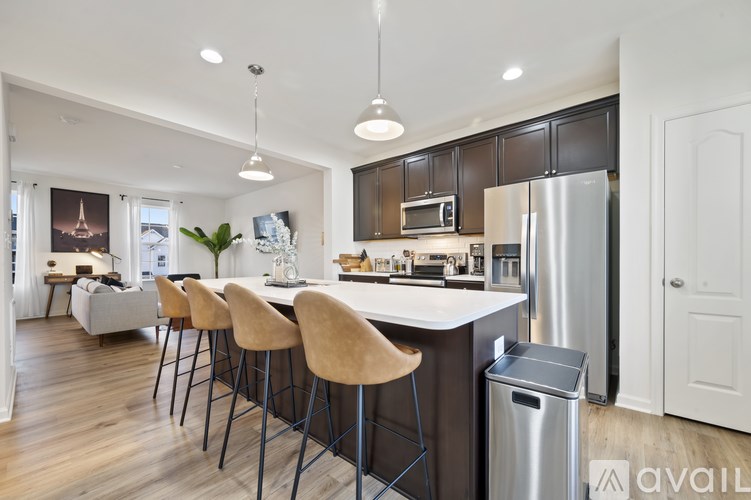 A kitchen with a bar area and a dining table.