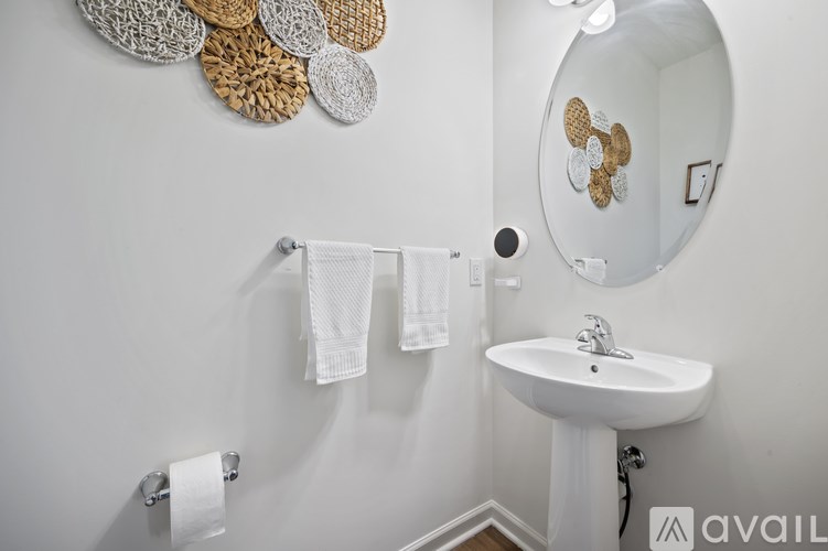 A bathroom with a white sink and a mirror.