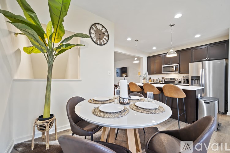 A modern dining room with a large table and chairs.