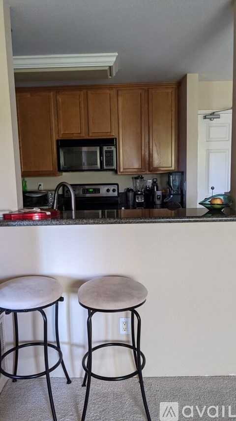 Two bar stools are in front of a kitchen counter.