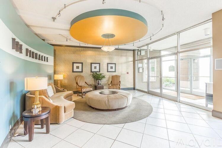 A living room with a round light fixture and a couch.