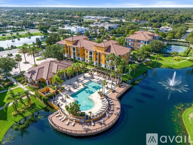 A large house with a pool in the middle of a lake.