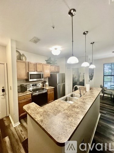 A kitchen with granite countertops and stainless steel appliances.