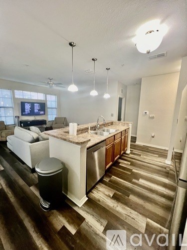 A kitchen with a wooden floor and a white counter.