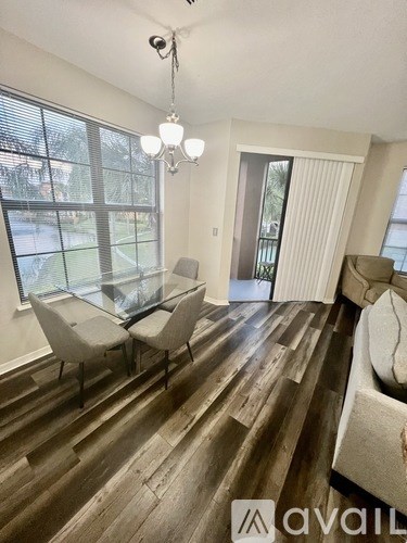 A living room with a glass table and chairs.