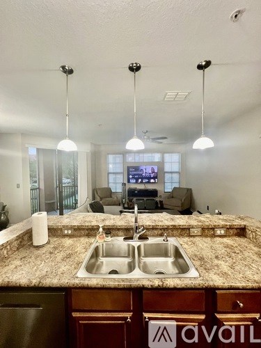 A kitchen with granite countertops and a sink.