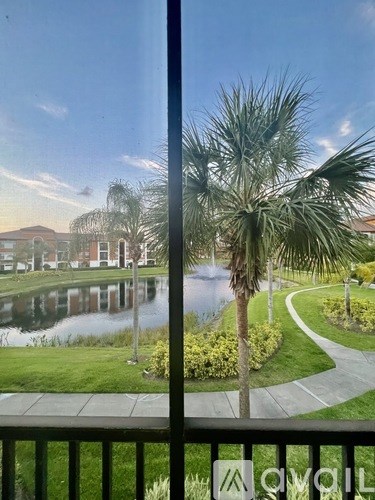 A view of a lake and houses from a balcony.