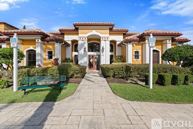 A large, multi-colored building with a walkway leading to the entrance.