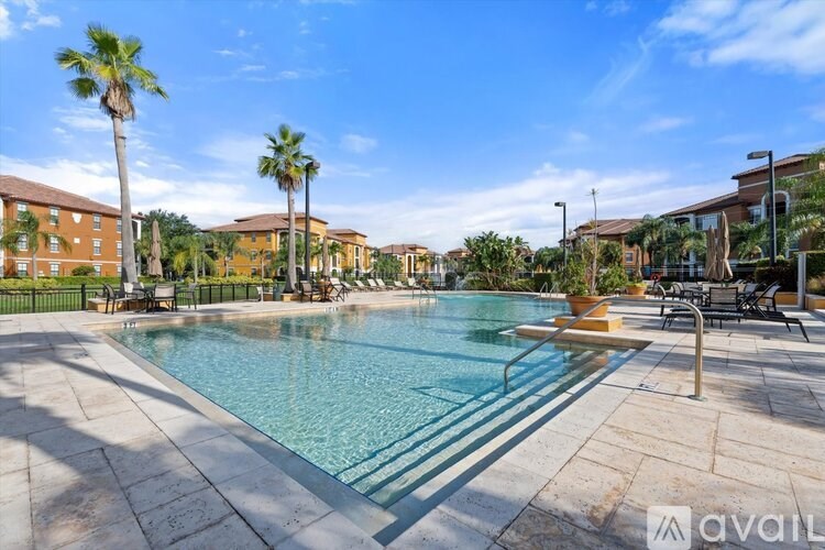 A pool surrounded by palm trees and chairs.