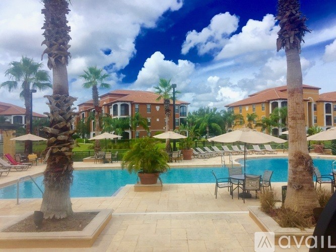 A pool surrounded by palm trees and chairs with umbrellas.
